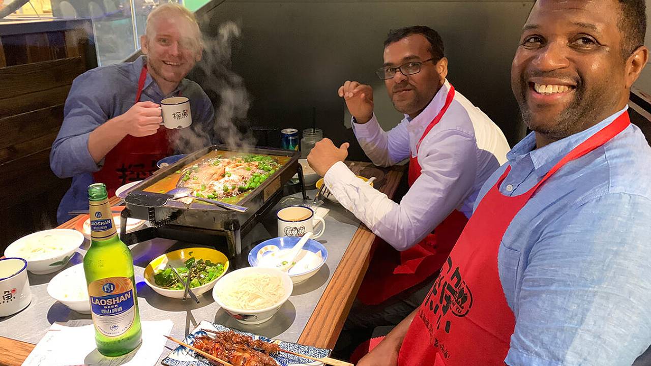 Intern David with other interns having dinner