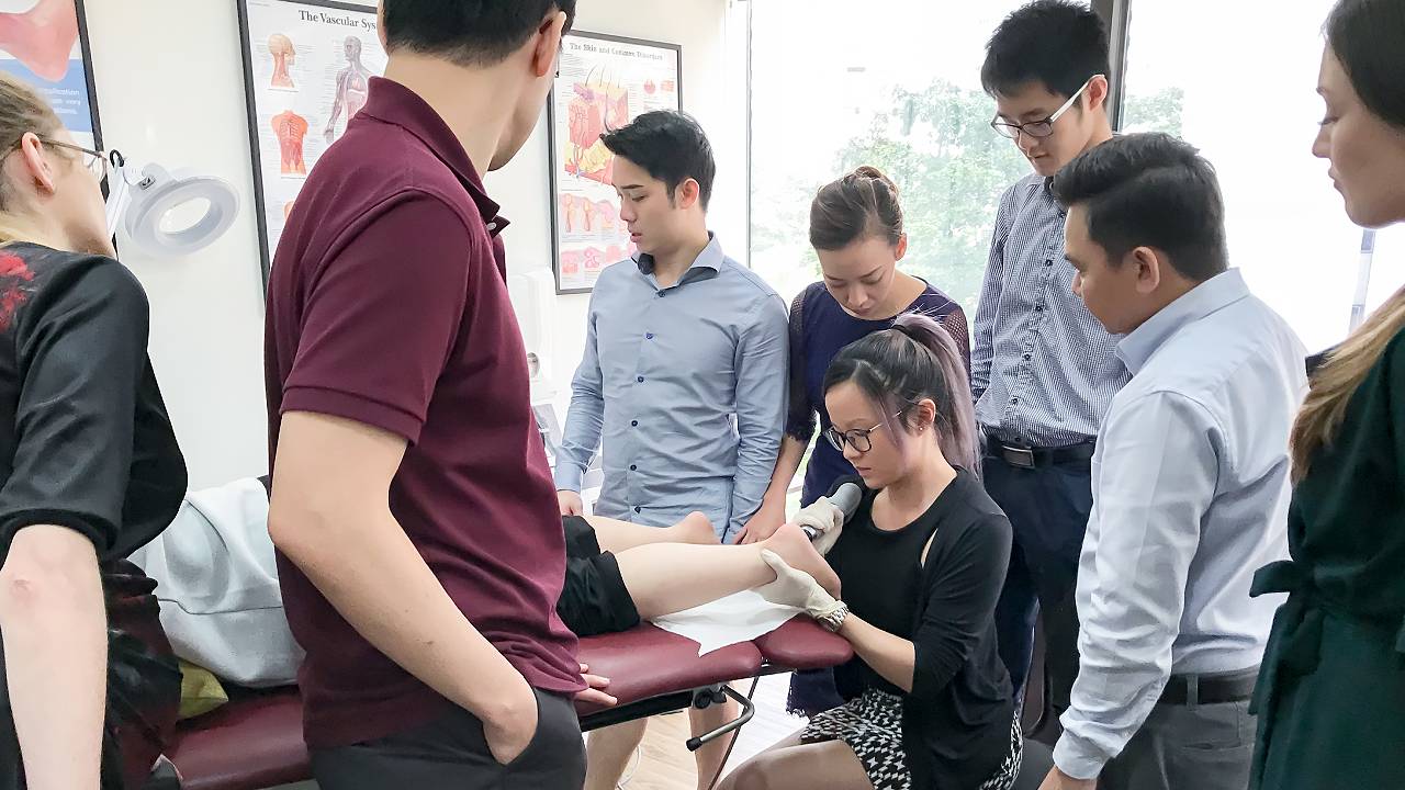 Intern Practising with Shockwave | East Coast Podiatry