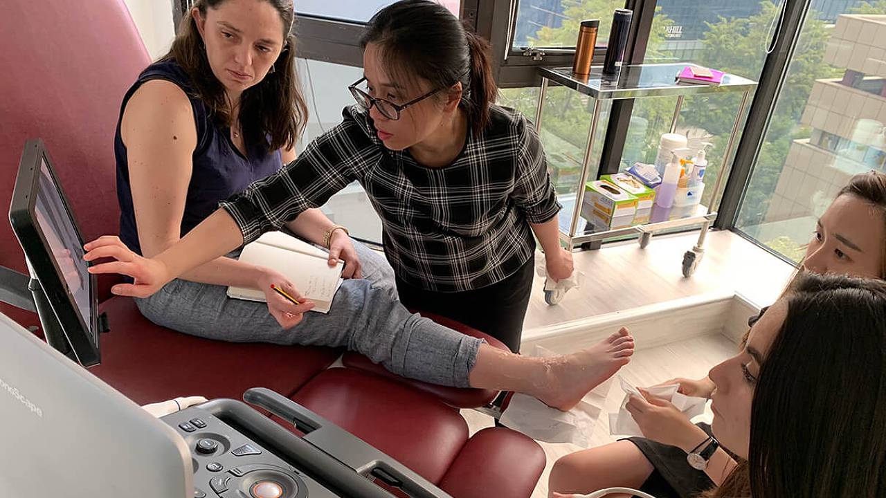 Podiatrist Ari demonstrating to Intern Jennifer
