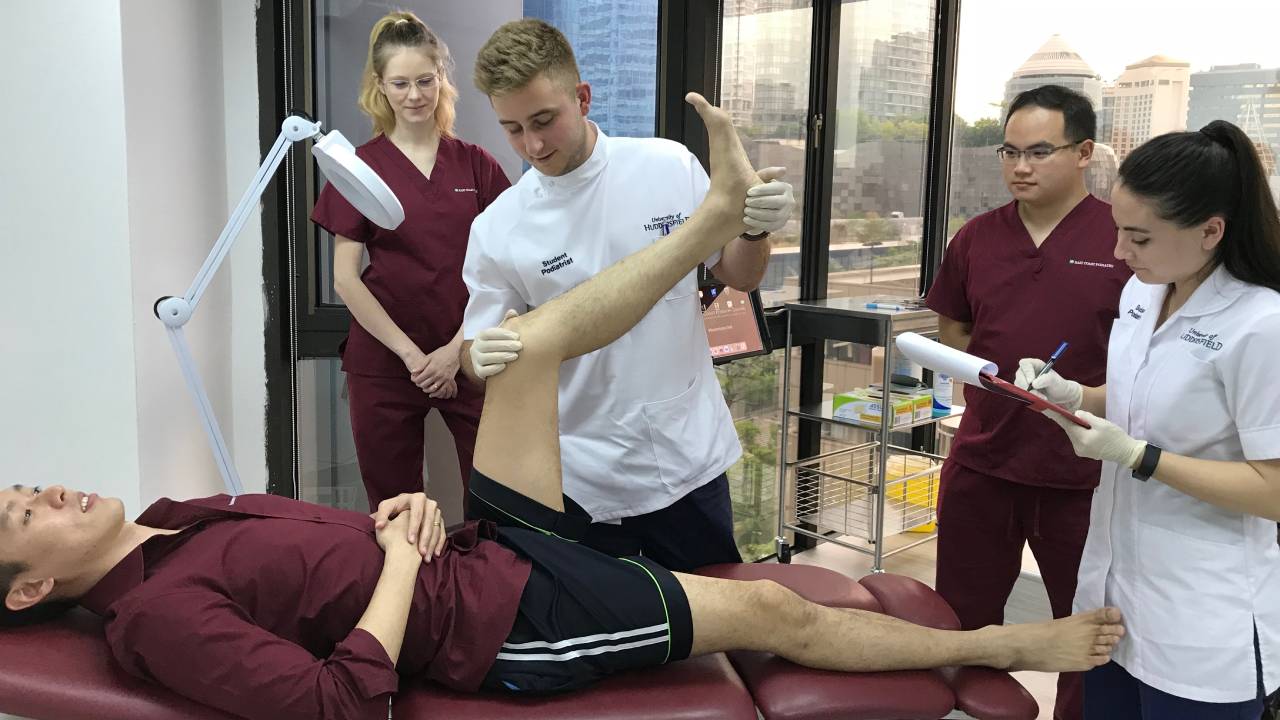 Interns assessing patient's foot | East Coast Podiatry